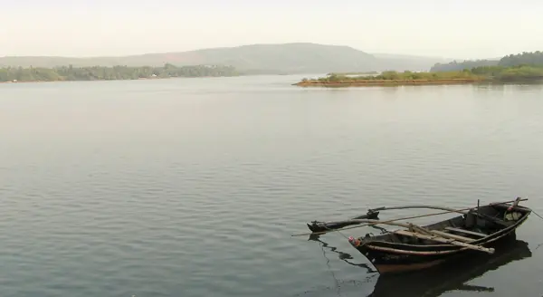 A wooden boat at rest on the Devbag backwaters